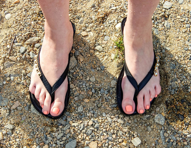 Beautiful Slates flip flops on women 's feet on the beach. Вид сверху. - Фото, изображение