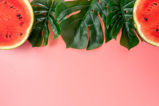 Watermelon with palm tree leaf on pink background. Creative minimal summer concept. - Fotoğraf, Görsel