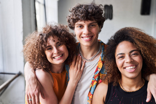 Happy young man hugging his female friends - Foto, afbeelding