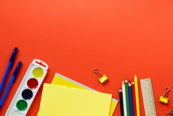 Flat lay of various school supplies on a red background. Space for text - Fotoğraf, Görsel