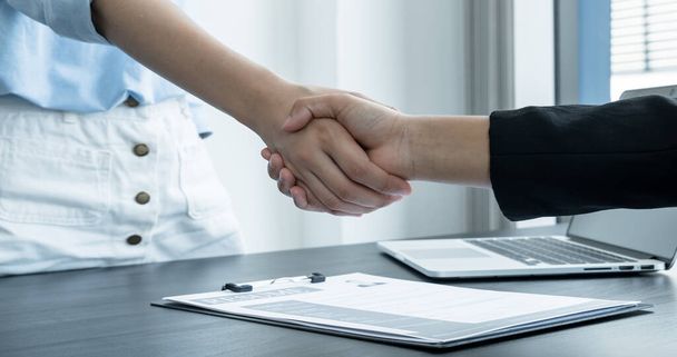 Friendly businessmen and executives shake hands after successful agreement with employment contracts, recruitment, and employment concepts. - Photo, Image