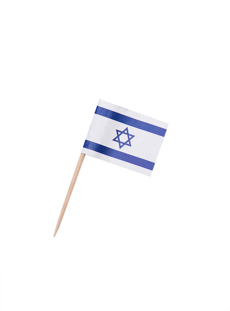 Tooth pick wit a paper flag of Israel, Israeli flag on a wooden toothpick - Фото, изображение