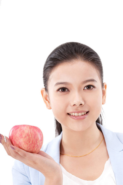 Oriental fashion woman holding red apple - Foto, immagini