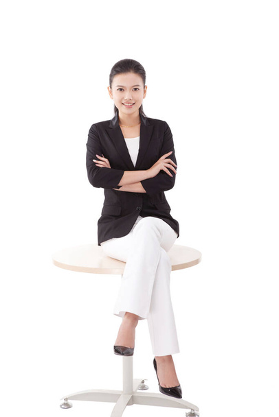 Oriental business woman sitting on the table - Zdjęcie, obraz