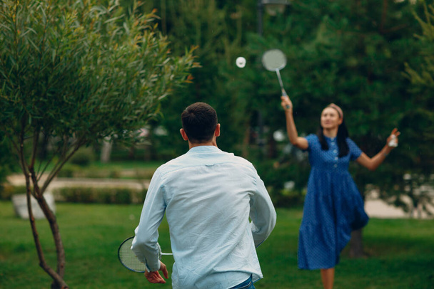 Man and woman playing badminton in the park - Photo, Image