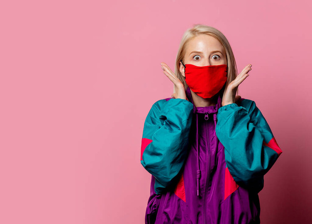 Woman in face mask and 80s clothes on pink background  - Foto, Bild