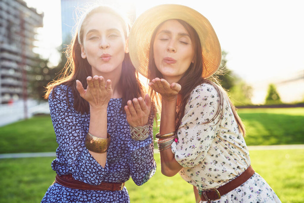  Young beautiful two woman blowing a kiss                               - Photo, Image