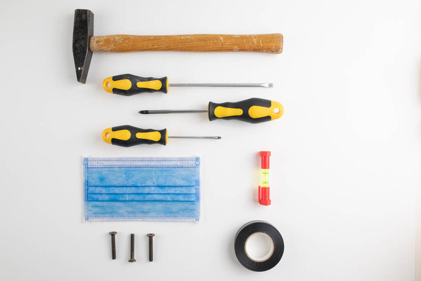 Background of a skilled technician with screwdriver and hammer for work - Photo, Image