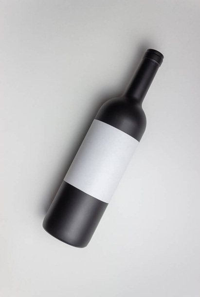 Black wine bottle on a white background. Mock-up. Copy space - Fotoğraf, Görsel