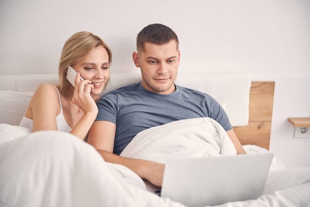 Loving young couple staying together with gadgets - Photo, Image