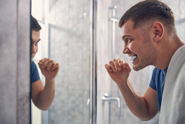 Young brunette man staying at home and caring about hygiene - Photo, Image