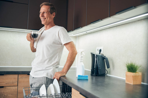 Smiling kind adult male drinking his morning coffee - Foto, Imagem