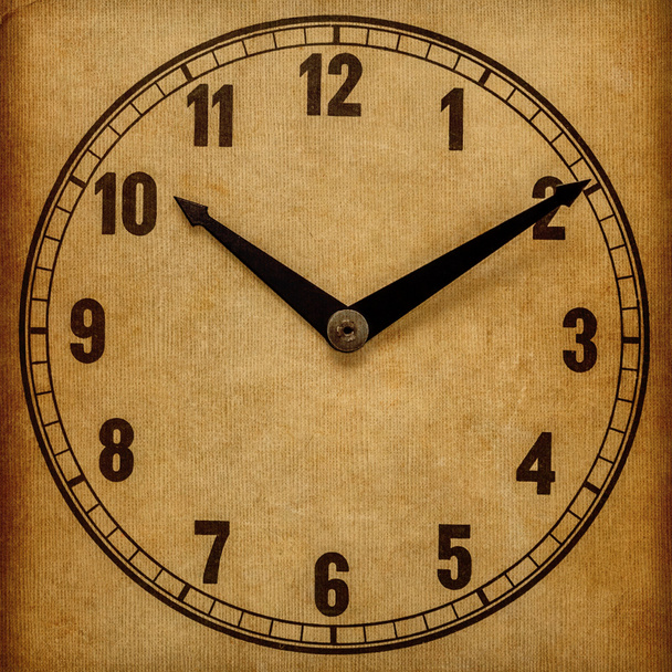 Textured old paper clock face showing 10:10 - 写真・画像