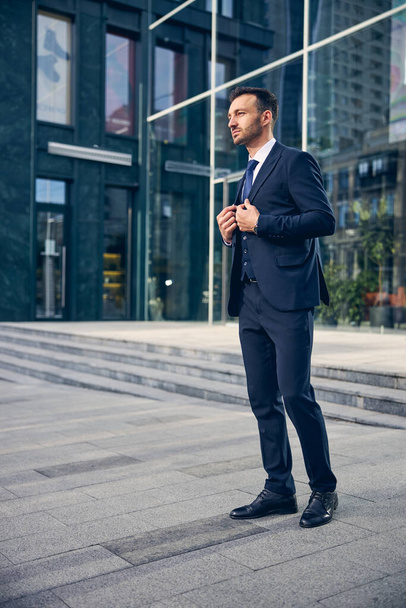 Young brunette male standing near business center - Foto, Imagem