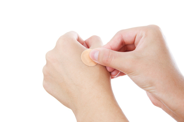 Bonding medicated plaster on woman's hand - Фото, зображення