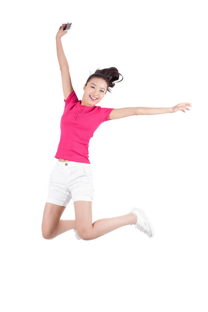 	Young woman jumping in air with arms outstretched,on white background,portrait	 - Foto, Bild