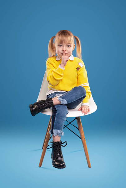 Little girl in stylish clothes showing silence gesture - Fotoğraf, Görsel