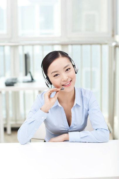 	Female office worker wearing headset,portrait	 - Photo, Image