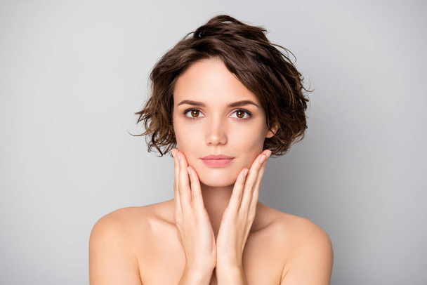 Closeup photo of beautiful nude lady short bob hairdo rejuvenation spa salon procedure soft facial skin touch arms cheekbones aesthetic look isolated grey color background - 写真・画像