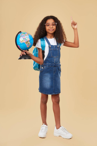 Smart black girl during geography lesson - Photo, image