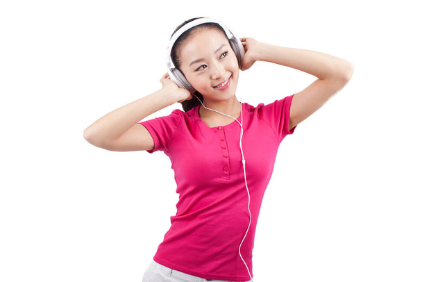	Young woman listening to music with headphones	 - Valokuva, kuva