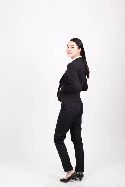 A young business woman standing in different positions - Фото, изображение