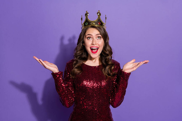 Photo of attractive crazy lady festive party prom queen nomination excited crown on head overjoyed raise hands wear sequins burgundy short dress isolated pastel violet color background - Foto, Imagen