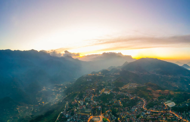 Aerial view of panorama landscape at the hill town in Sapa city, Lao Cai Province, Vietnam in Asia with the sunny light and sunset, mountain view in the clouds - Foto, Imagen