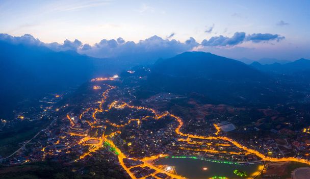 Aerial view of panorama landscape at the hill town in Sapa city, Lao Cai Province, Vietnam in Asia with the sunny light and sunset, mountain view in the clouds - Foto, Imagem