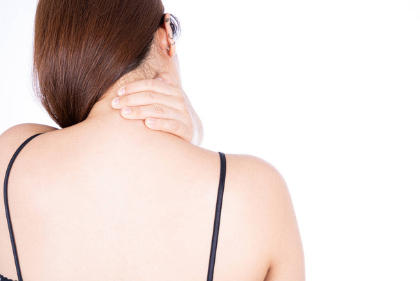 A woman feeling exhausted and suffering from shoulder and neck pain and injury on isolated white background. Health care and medical concept. - Foto, imagen
