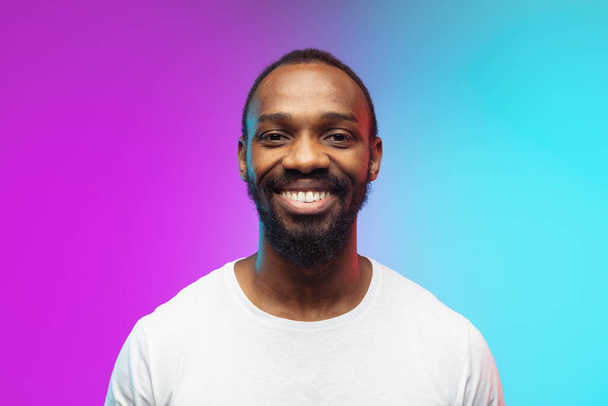 African-american young mans portrait on gradient studio background in neon, close up - Valokuva, kuva