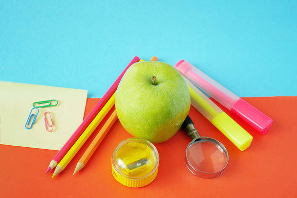 Back to school, books pile, pencils, apple, globe and apple over chalkboard background - Photo, Image
