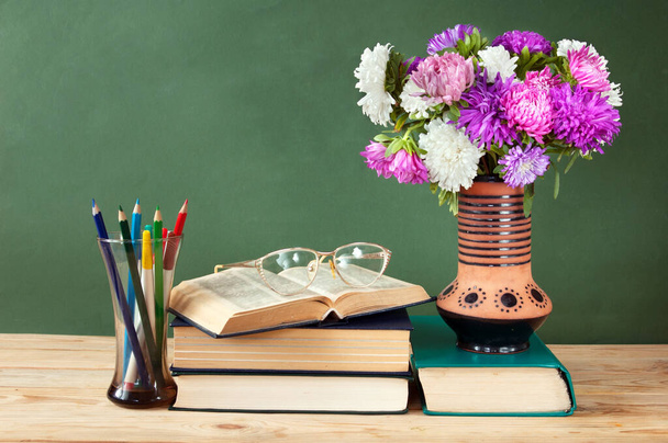 Il concetto della Giornata Mondiale dell'Insegnante. Mazzo di fiori, mappa, globo e libri mucchio - Foto, immagini