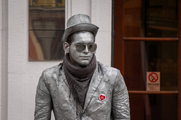 Bratislava, Slovakia - July 5th 2020: A street performer mimicking the silver statues in the old town in Bratislava, Slovakia - 写真・画像