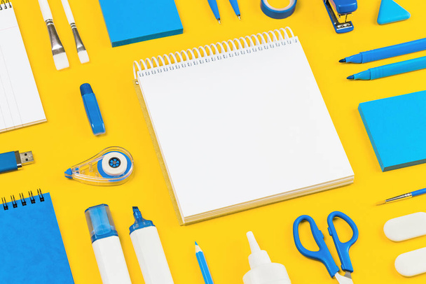 Blue and white assorted office and school supplies stationery on yellow flat lay. Organized knolling for back to school or education and craft concept. Selective focus. Copy space. Template or mockup - Photo, Image
