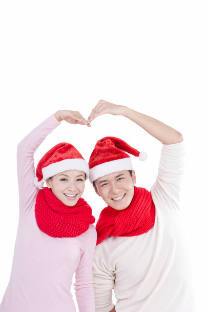 	Portrait of young couple wearing Santa hats,smiling	 - Fotoğraf, Görsel