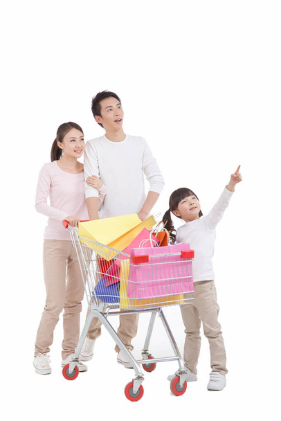 	Portrait of daughter with parents ,pushing shopping cart,looking away	 - Foto, imagen