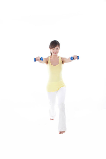 	Portrait of woman exercising with dumbbell	 - Fotó, kép