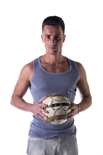 Handsome young man in tanktop holding soccer ball - Foto, Bild