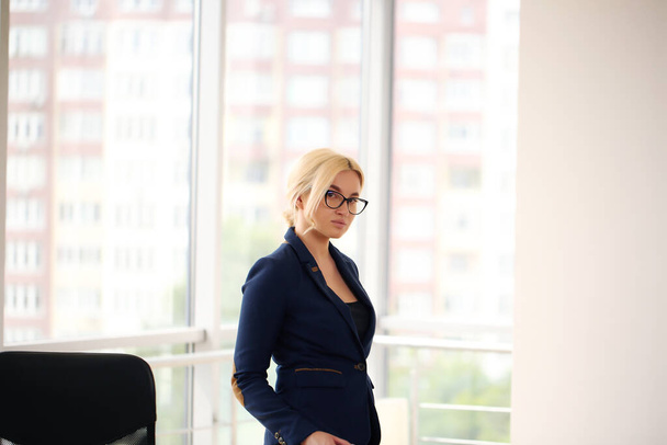 Portrait of a pensive businesswoman in a suit thinking and planning, - Fotó, kép