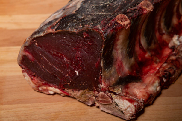 Raw dry aged ribs on wooden board - Photo, image