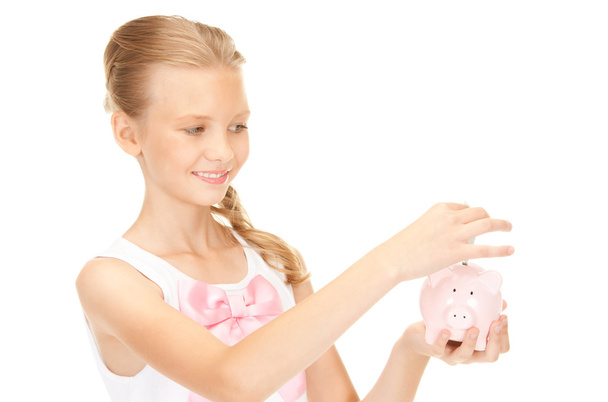 Lovely teenage girl with piggy bank and money - Valokuva, kuva