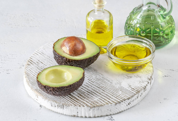 Fresh avocado with avocado oil on the wooden board - Photo, Image