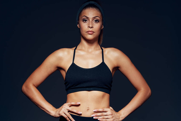 young sporty woman bodybuilder posing in studio  - Фото, изображение