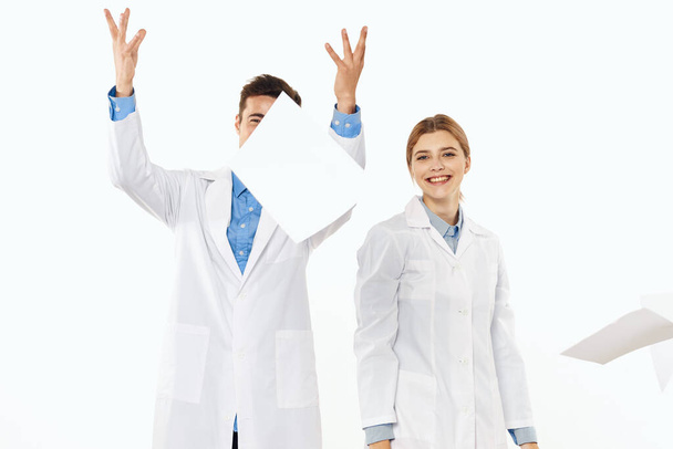 Young doctors throwing papers  in studio, isolated background.  - Fotoğraf, Görsel