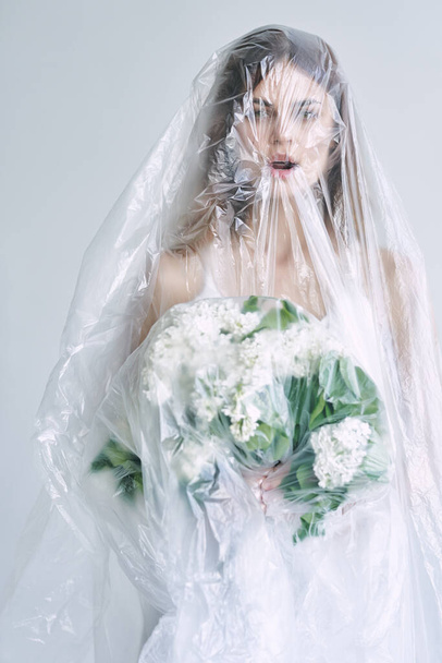 young bride covered with plastic tape  - Valokuva, kuva