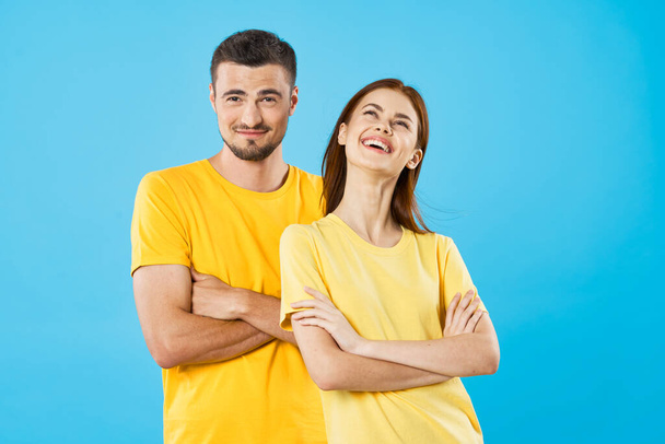 young beautiful couple posing in studio on isolated background - Photo, Image