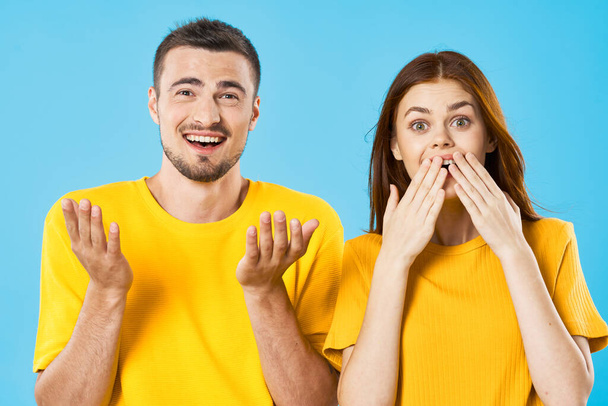 surprised young woman and man on blue background  - Photo, Image