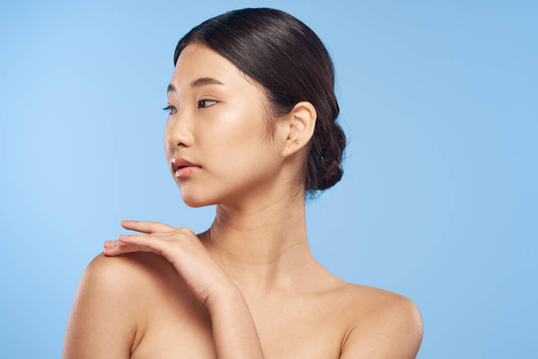 Young beautiful asian woman looking away   in studio on isolated background - Photo, Image