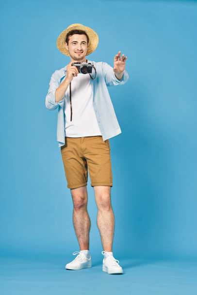 young handsome man tourist with camera in studio - Foto, imagen